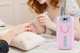 woman using nail drill to give a manicure