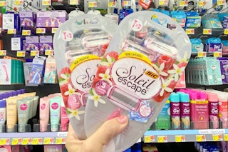 person holding 2 packs of bic soleil razors