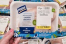hand holding a package of perdue fresh chicken breasts at kroger