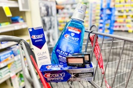 crest toothpaste and mouthwash with maybelline eyeshadow in a cart