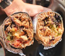 Two halves of a massive Moe's Southwest Grill burrito