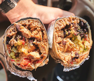 Two halves of a massive Moe's Southwest Grill burrito