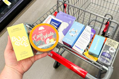 person holding bubble and tree hut skincare over a cart with more skincare products in it