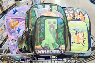 3 backpacks in a cart featuring bluey, minecraft, and princesses