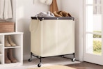 StorageWorks Laundry Hamper 2 Section full of clothes in a mud room.
