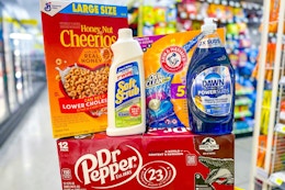  honey nut cheerios, soft scrub, arm & hammer, dawn, dr pepper on a yellow shopping cart