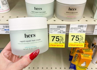 hand holding hers next to clearance tag