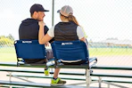 Lifestyle image of the Ozark Trail Stadium Seat being used by a couple at a sports game 