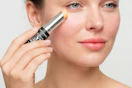woman applying retinol eye stick