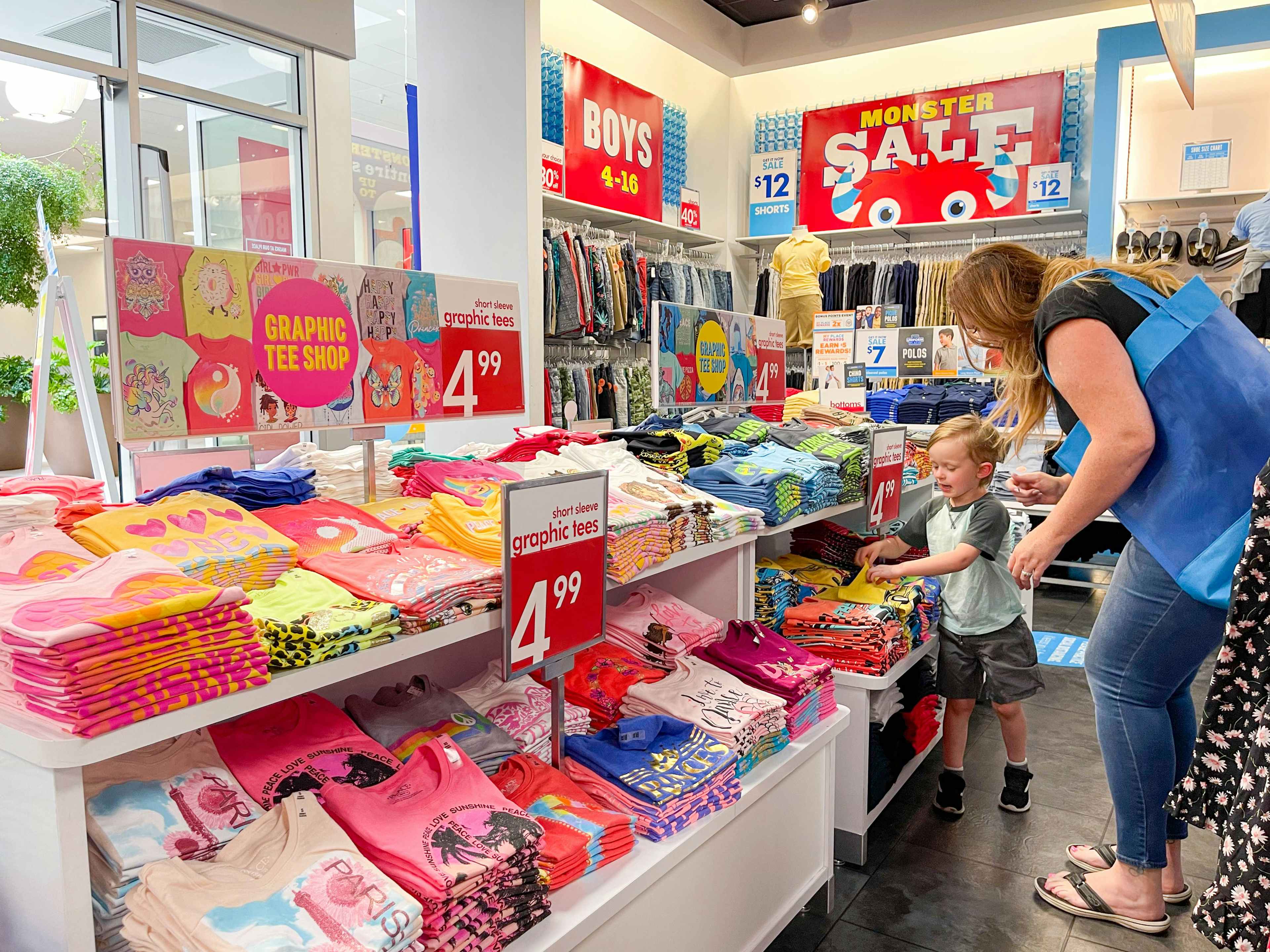 a woman shopping with a little boy in the children's place