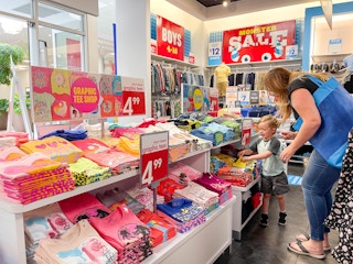 a woman shopping with a little boy in the children's place