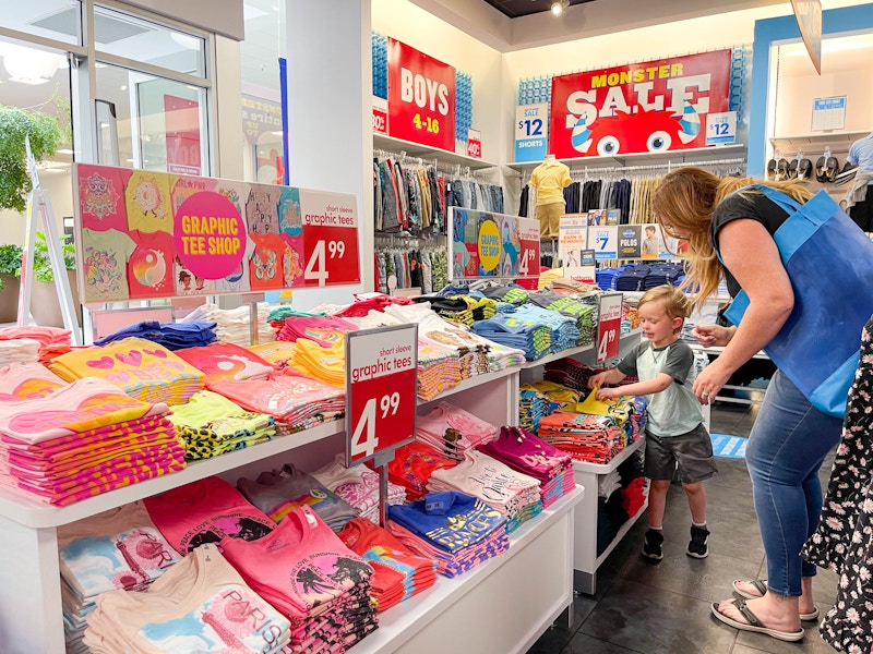 a woman shopping with a little boy in the children's place