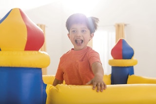 A child jumping in an Intex inflatable castle-themed bounce house