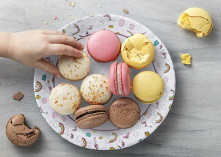 a unicorn-themed plate with macaroons in it