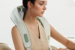 a woman with a neck massager
