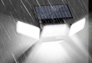 a motion sensor solar light on a wall while it's raining