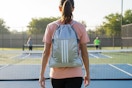 a woman wearing an adidas backpack