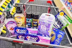 softsoap hand soap, crest toothpaste, axe body spray, gillette and venus razors, and coppertone lip balm in a cart
