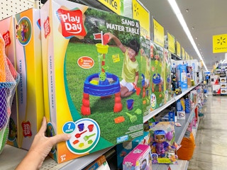 hand holding play day sand and water table on walmart shelf