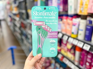 hand holding a 4-pack of Skintimate razors