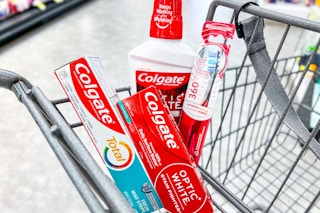 two Colgate mouthwash, toothpaste and toothbrush