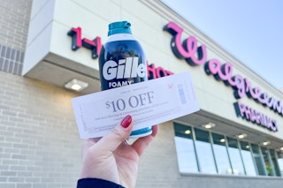 person holding a can of gillette foamy with a $10 register reward in front of walgreens