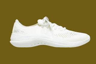 A white sneaker on a green background