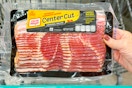 hand holding a pack of oscar mayer bacon