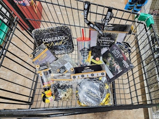 graduation party supplies in a cart
