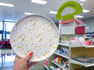 hand holding up ceramic candle tray at Target