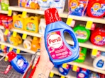 hand holding persil laundry detergent in cvs
