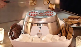 an indoor smores maker with people making smores
