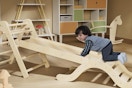 kid using a montessori pikler triangle climber set