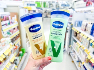 hand holding two vaseline lotion bottles