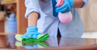 best cleaning products under $3 - A person using a microfiber cloth to clean a table