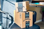 amazon boxes on a desk chair