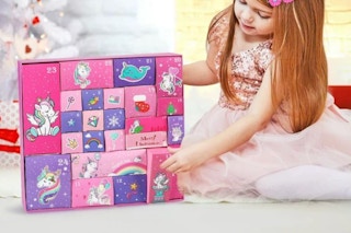 Girl holding the Yunaking  Unicorn Advent Calendar 2025.