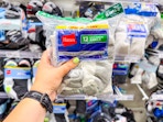hand holding a hanes kids' socks pack in front of target shelf