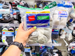 hand holding a hanes kids' socks pack in front of target shelf
