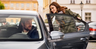 someone getting into an Uber for a ride