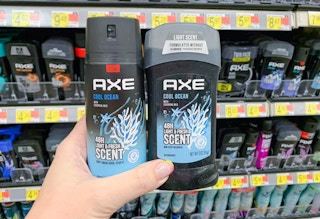 hand holding two axe body products in front of other products on walmart shelves