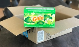 A box of gain dryer sheets, placed on an open Amazon delivery box.