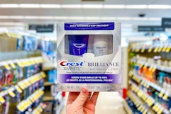 hand holding crest two-step whitening kit in walgreens aisle