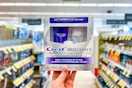 hand holding crest two-step whitening kit in walgreens aisle