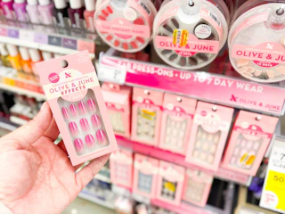hand holding olive and june nails in walgreens