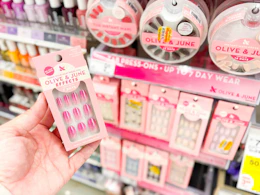 hand holding olive and june nails in walgreens