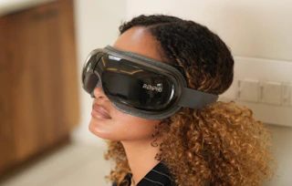 a person wearing an eye massager 