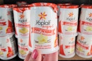 hand holding a yoplait yogurt cup