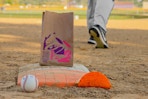 a person stealing a base on a baseball field