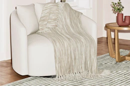 Lifestyle image of the Beautiful Woven Throw Blanket over an accent chair in home